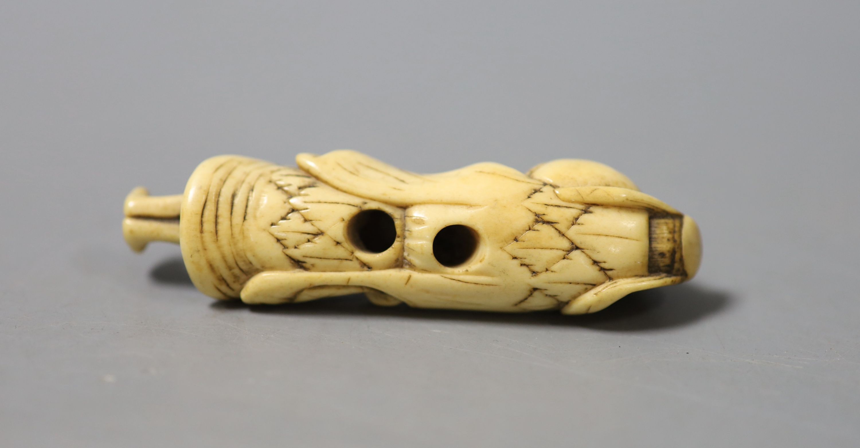 A late 18th/early 19th century Japanese carved stag antler netsuke modelled as a Sennin, 7.4 cm